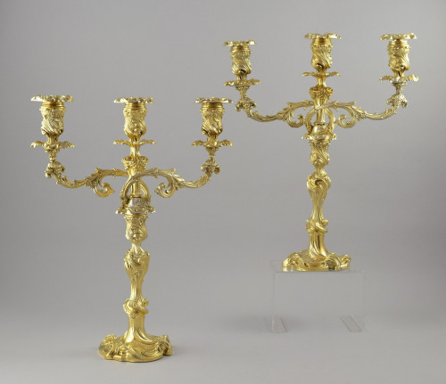 A pair of Victorian silver-gilt three light candelabra