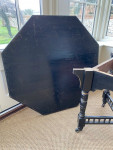 An ebonised octagonal centre table, stamped by Gillows circa 1900.