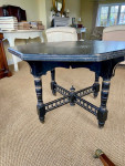 An ebonised octagonal centre table, stamped by Gillows circa 1900.