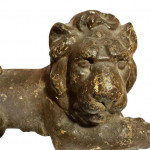 Cast figure of a recumbent lion