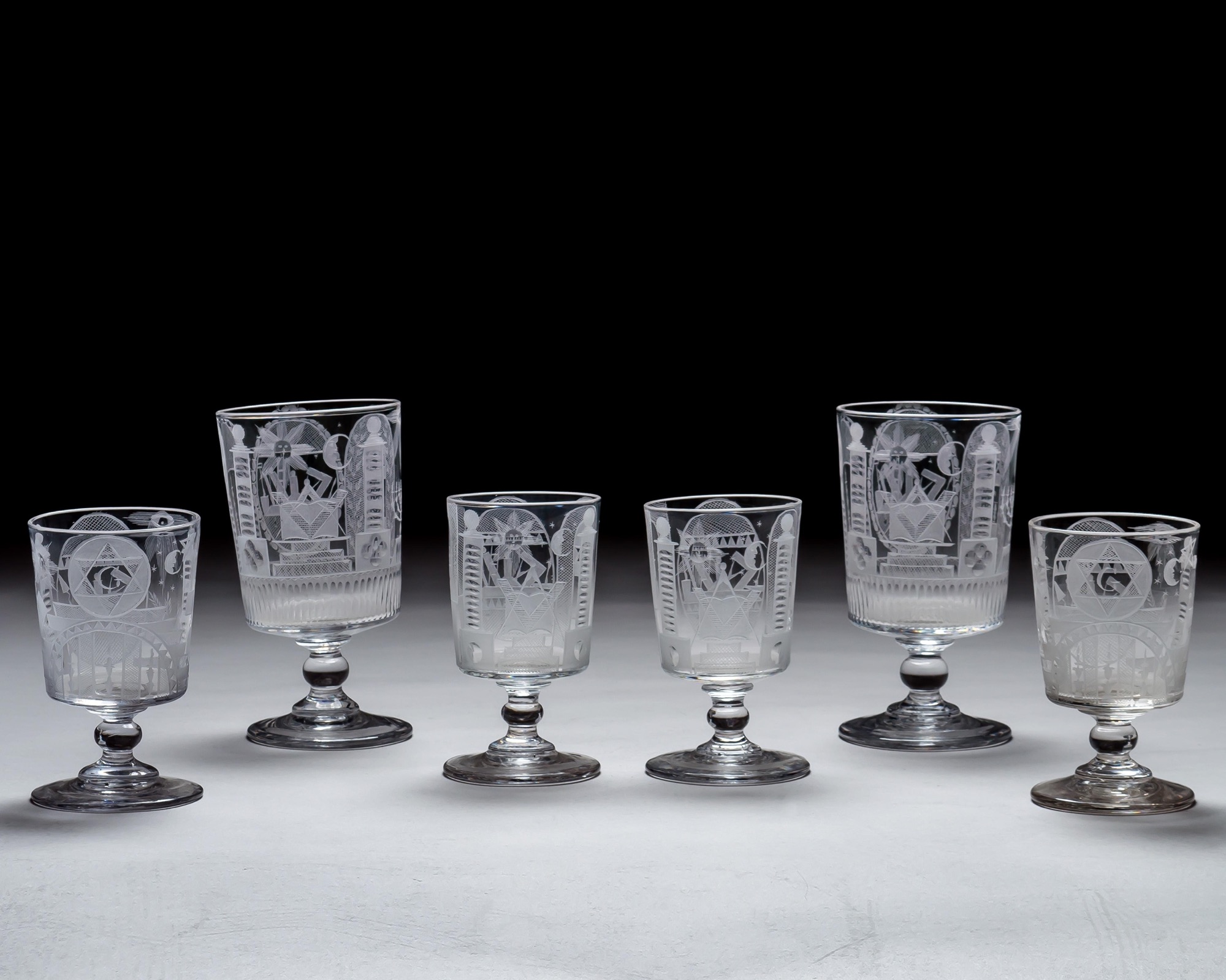 AN ENGRAVED GLASS SERVICE OF MASONIC INTEREST ALONG WITH A COLLECTION OF CORRESPONDING MASONIC REGALIA