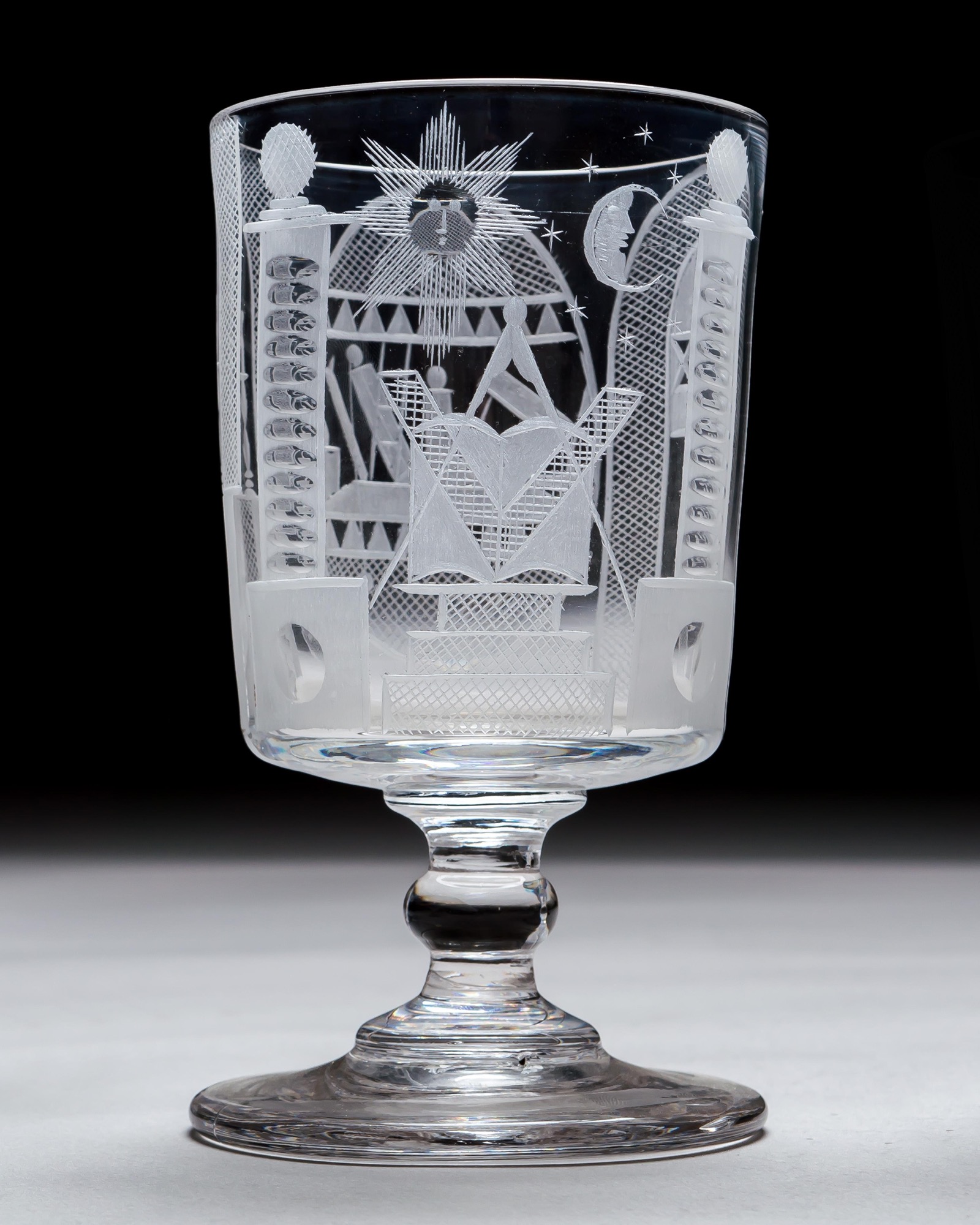 AN ENGRAVED GLASS SERVICE OF MASONIC INTEREST ALONG WITH A COLLECTION OF CORRESPONDING MASONIC REGALIA