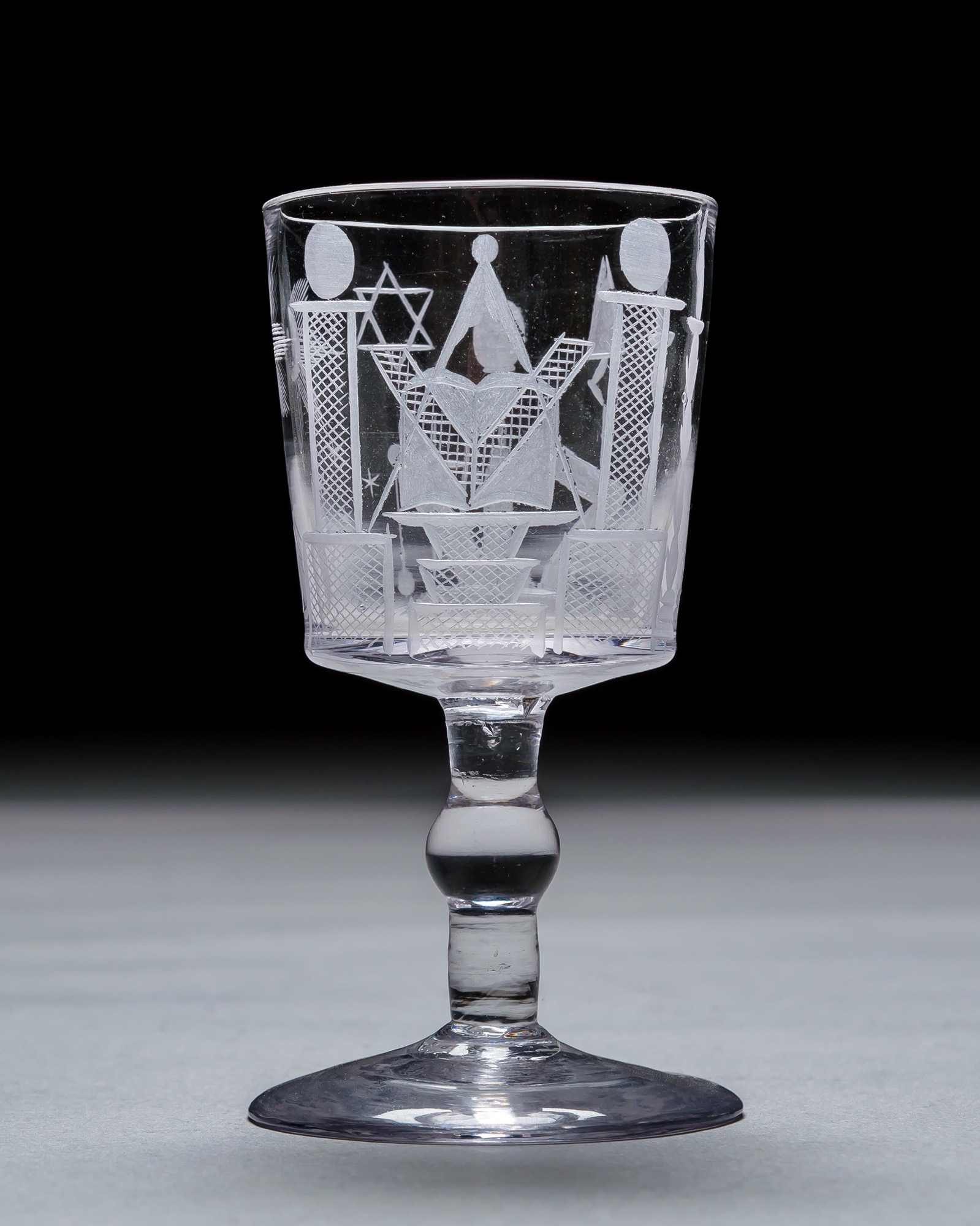 AN ENGRAVED GLASS SERVICE OF MASONIC INTEREST ALONG WITH A COLLECTION OF CORRESPONDING MASONIC REGALIA