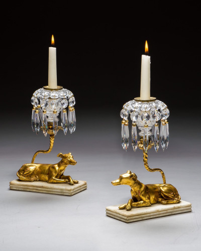 A PAIR OF GILT-WOOD GREYHOUND CANDLESTICKS