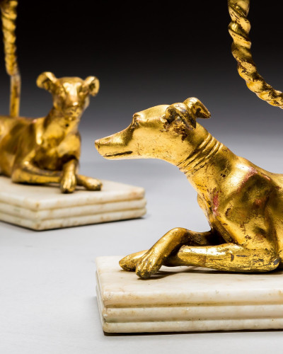 A PAIR OF GILT-WOOD GREYHOUND CANDLESTICKS