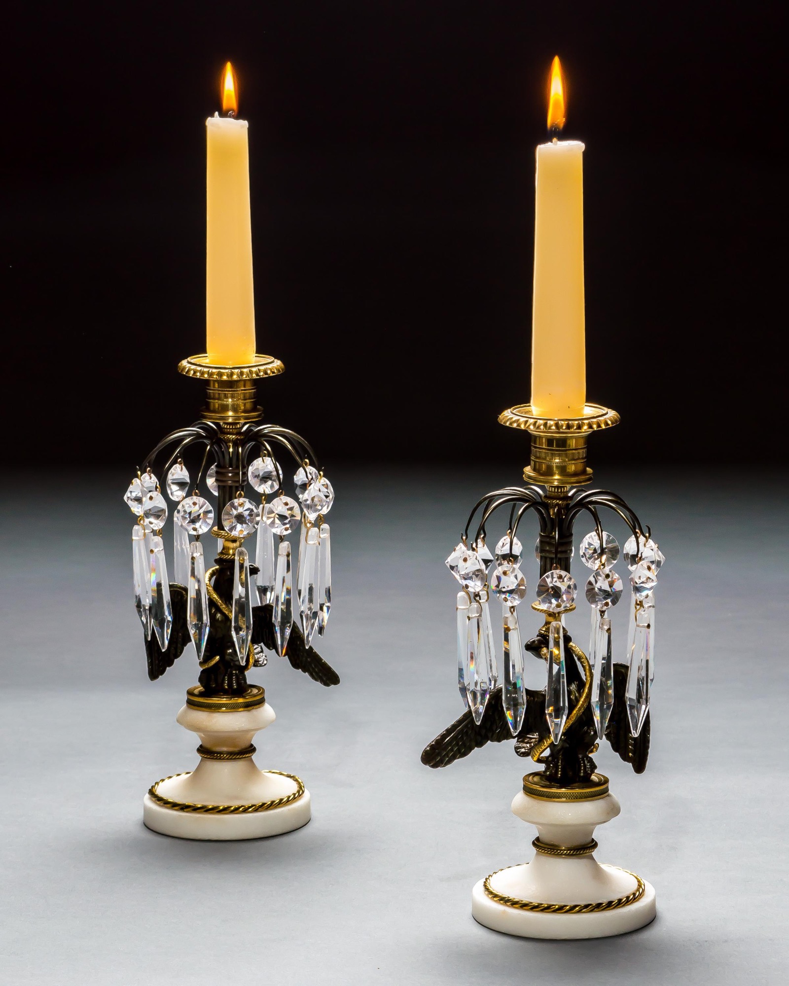 A PAIR OF REGENCY EAGLE CANDLESTICKS