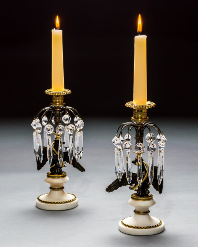 A PAIR OF REGENCY EAGLE CANDLESTICKS
