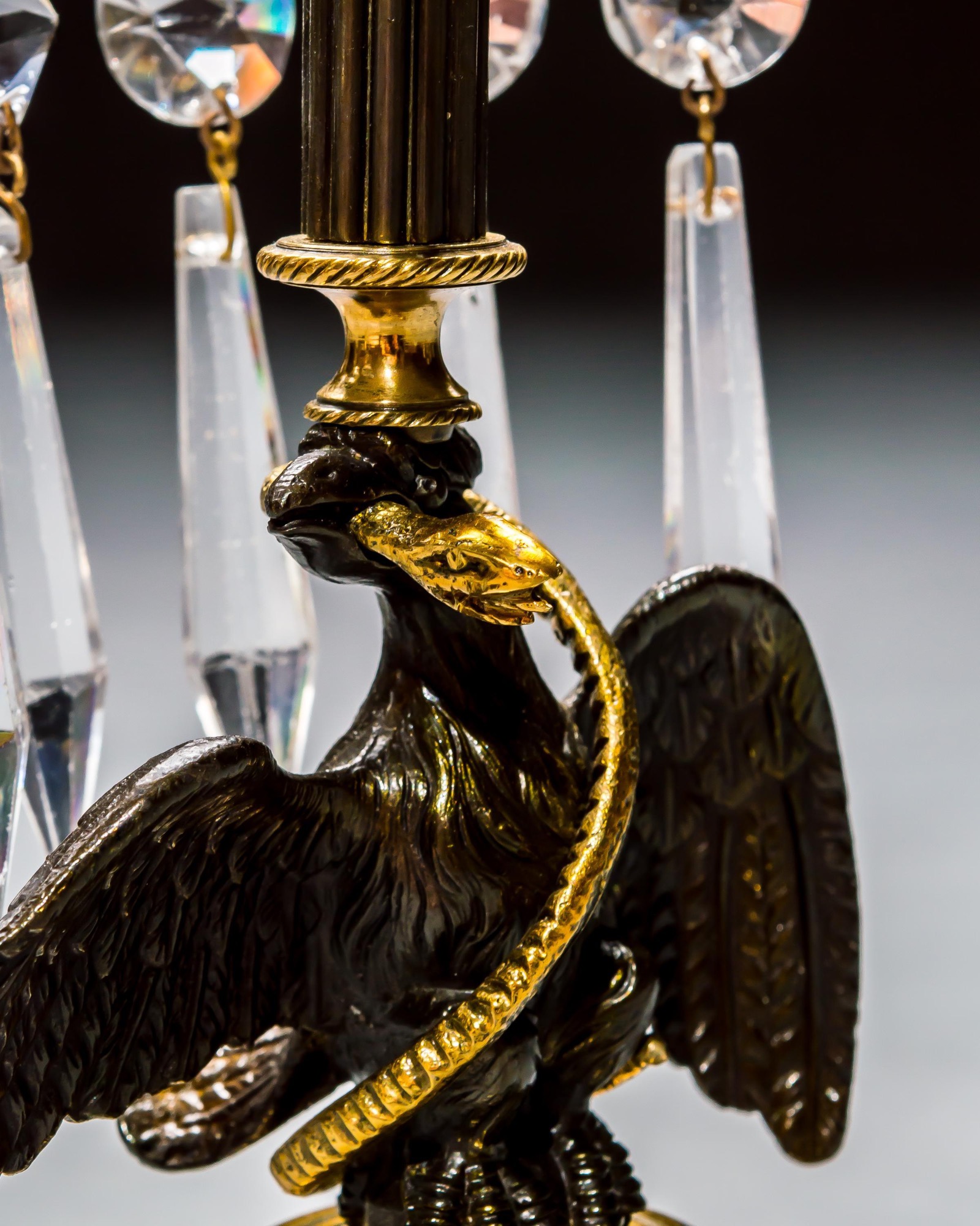 A PAIR OF REGENCY EAGLE CANDLESTICKS