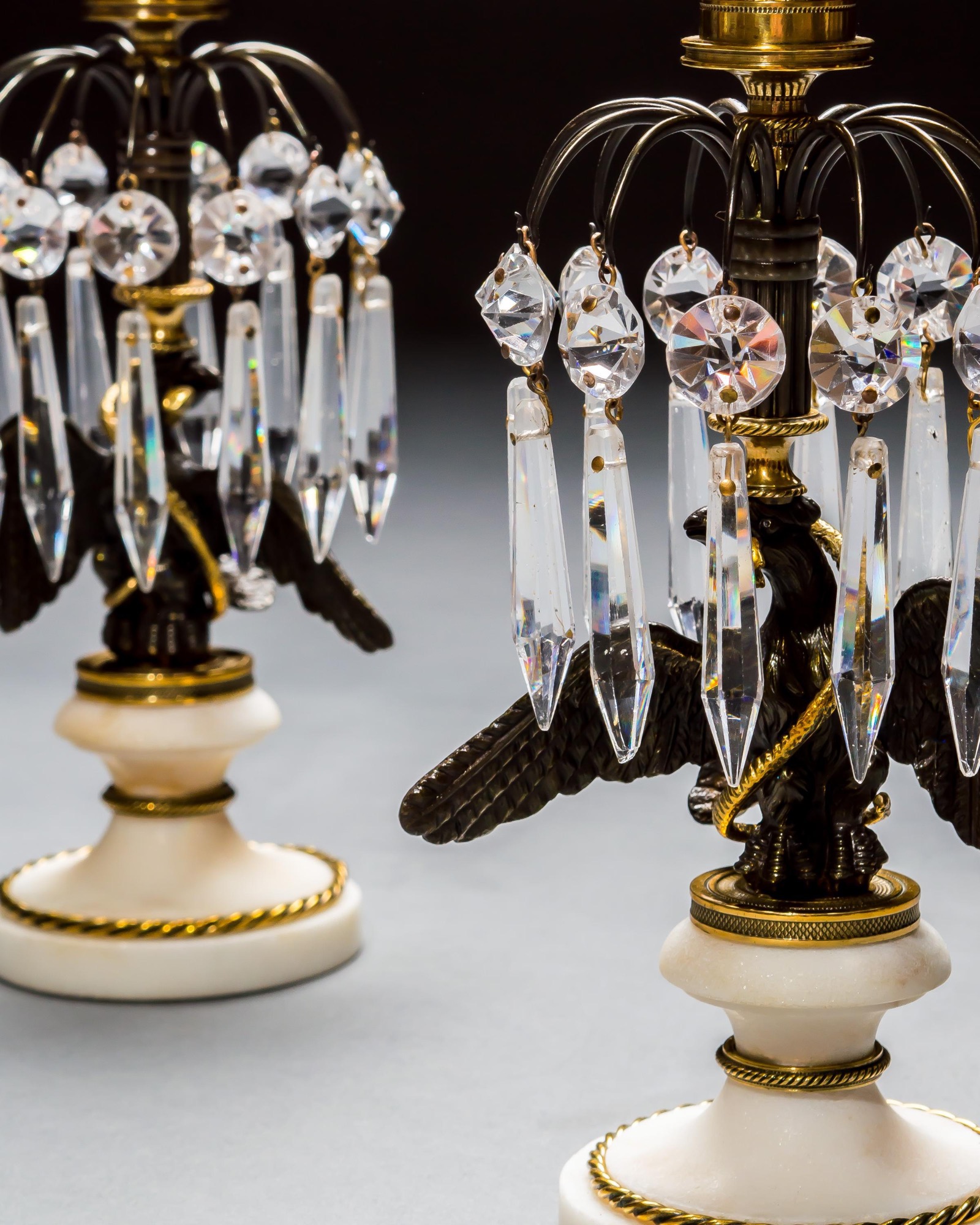 A PAIR OF REGENCY EAGLE CANDLESTICKS