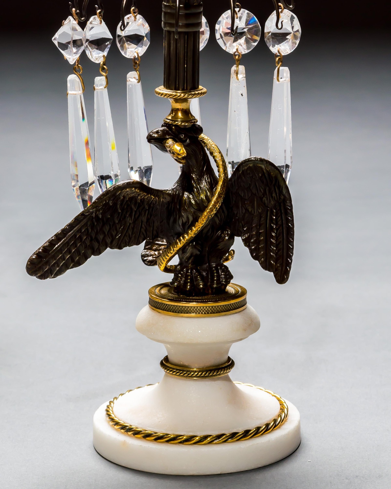 A PAIR OF REGENCY EAGLE CANDLESTICKS