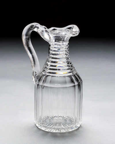 A GEORGIAN SLICE & STEP CUT CLARET JUG