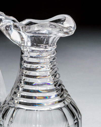 A GEORGIAN SLICE & STEP CUT CLARET JUG