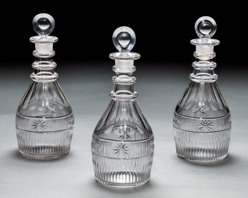 A SET OF THREE SLICE & FLUTE DECANTERS