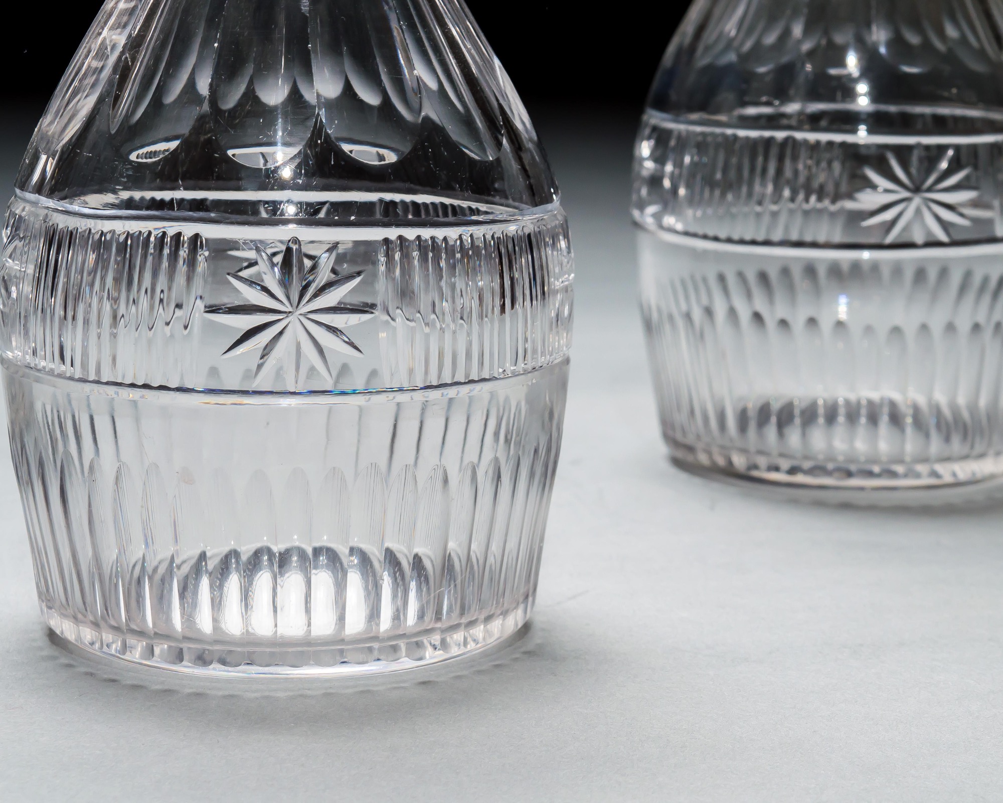 A SET OF THREE SLICE & FLUTE DECANTERS
