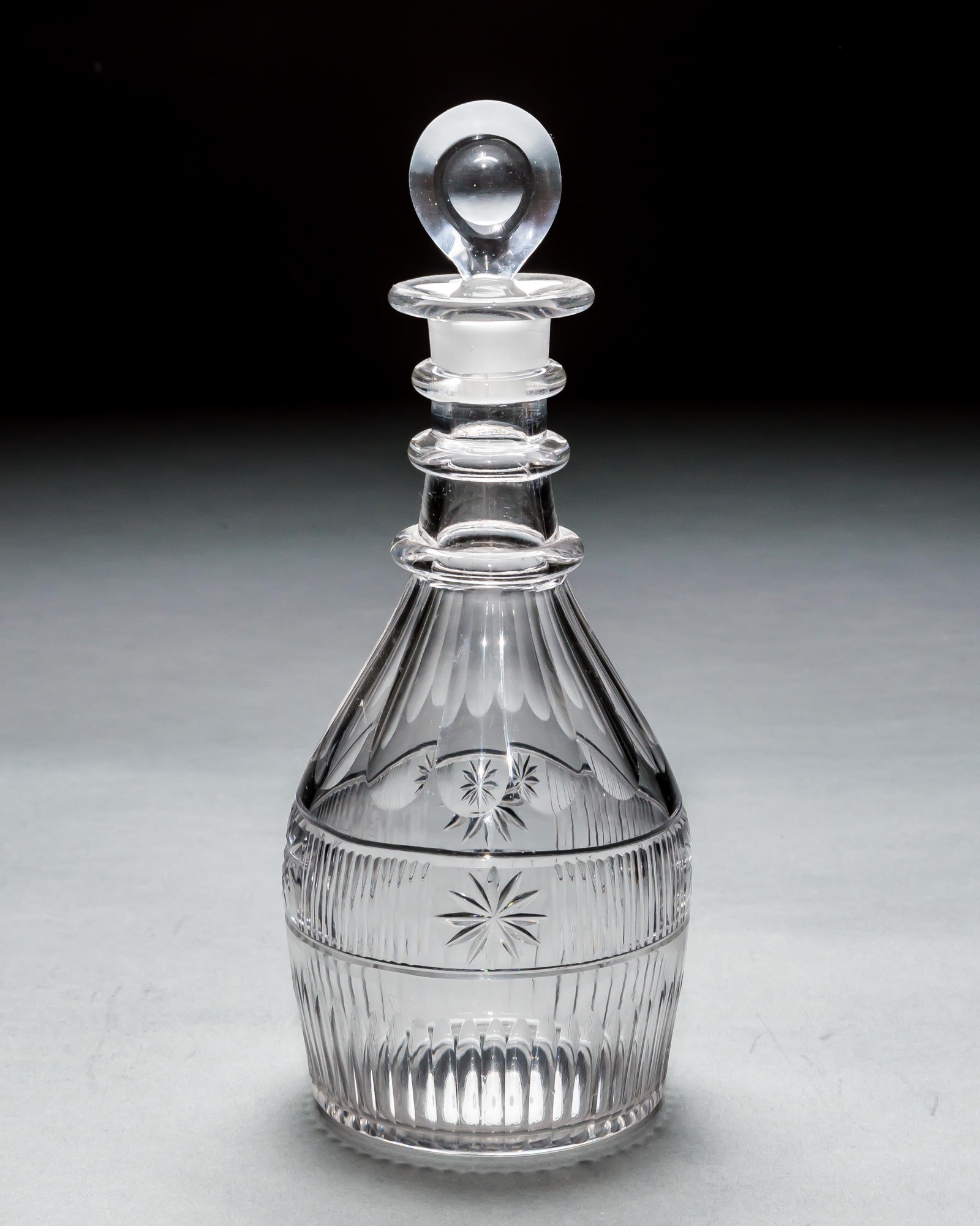 A SET OF THREE SLICE & FLUTE DECANTERS