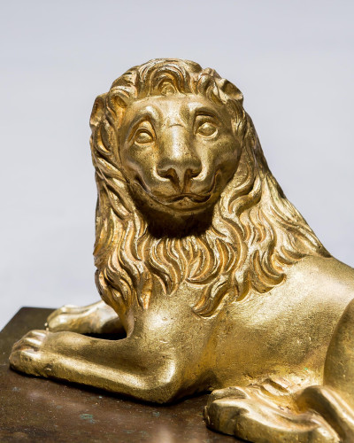 A MAJESTIC PAIR OF GILT & BRONZE LION CANDLESTICKS