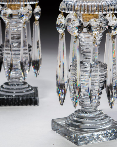 A PAIR OF STEP CUT REGENCY CANDLESTICKS