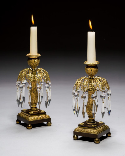 A PAIR OF GILT & BRONZE CANDLESTICKS