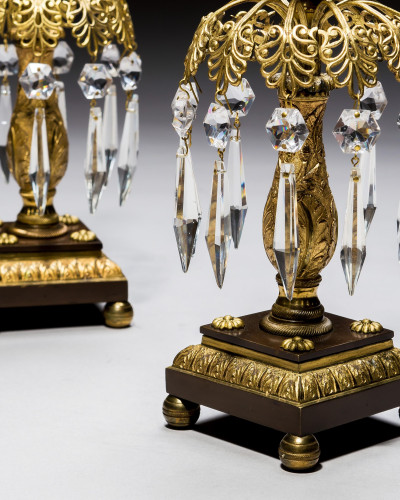 A PAIR OF GILT & BRONZE CANDLESTICKS