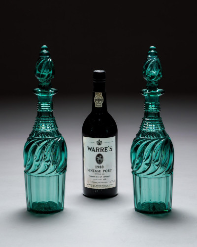 A PAIR OF ELABORATELY CUT GREEN DECANTERS