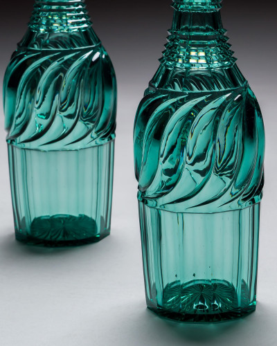 A PAIR OF ELABORATELY CUT GREEN DECANTERS