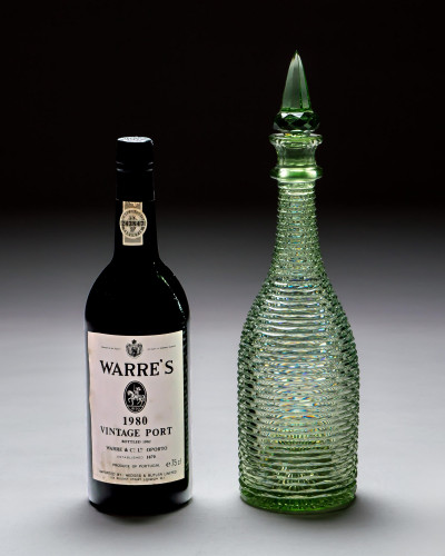 A HEAVILY CUT GREEN DECANTER