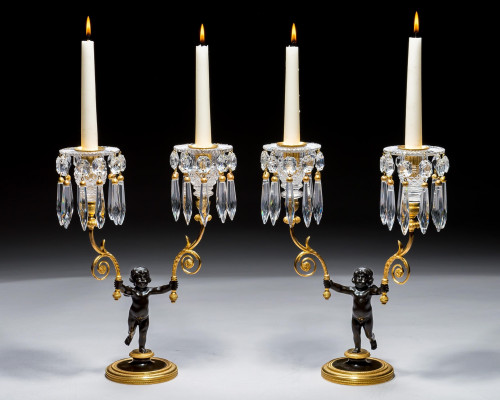 A PAIR OF REGENCY ORMOLU & BRONZE BOY CANDELABRA