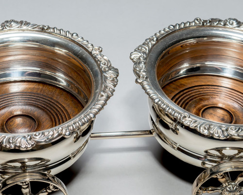 A SILVER PLATED WAGON DECANTER STAND