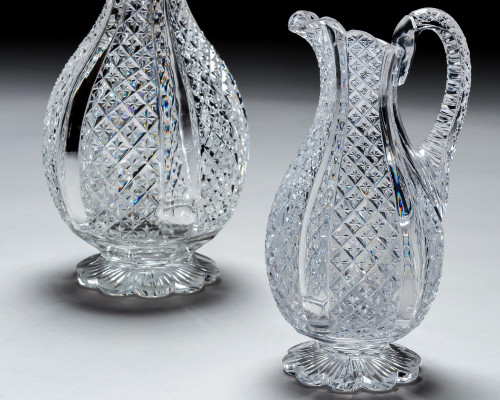 A FINELY CROSSOVER DIAMOND CUT DECANTER WITH MATCHING PAIR OF JUGS