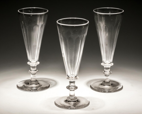 A SET OF THREE SLICE CUT CHAMPAGNE FLUTES