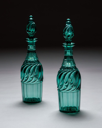 A PAIR OF ELABORATELY CUT GREEN DECANTERS