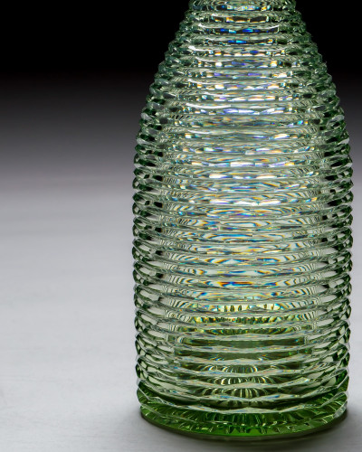 A HEAVILY CUT GREEN DECANTER