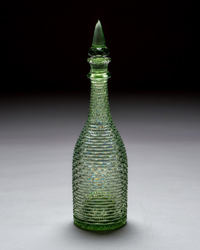 A HEAVILY CUT GREEN DECANTER