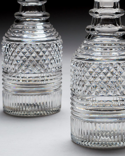 A PAIR OF HEAVILY CUT REGENCY SPIRIT DECANTERS