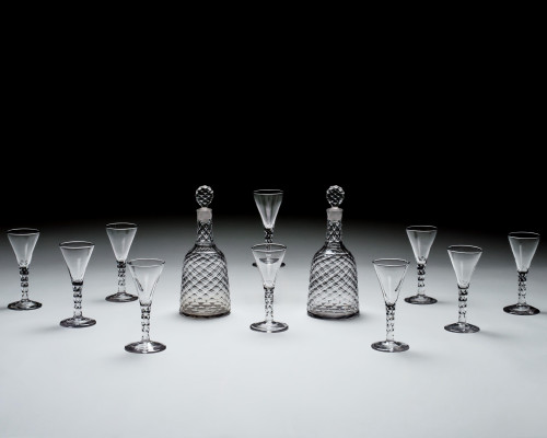 A SUITE OF INCISED DIAMOND CUT DECANTERS & WINE GLASSES BY WILLIAM PARKER