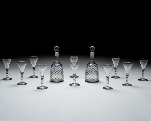 A SUITE OF INCISED DIAMOND CUT DECANTERS & WINE GLASSES BY WILLIAM PARKER