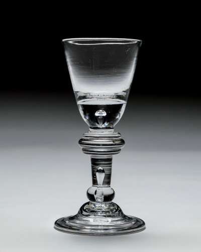 AN ANNULAR KNOPPED BALUSTER WINE GLASS
