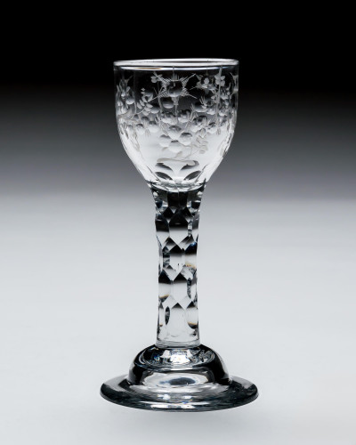 AN ELEGANT ENGRAVED FACET STEM WINE GLASS