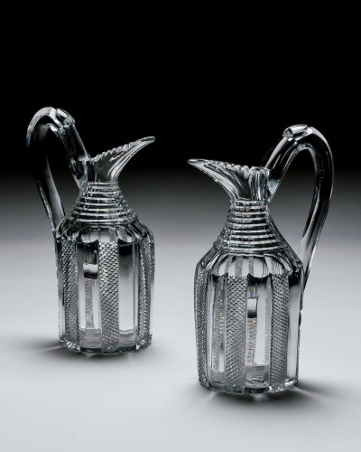 A STRIKING PAIR OF PILLAR & DIAMOND CUT CLARET JUGS