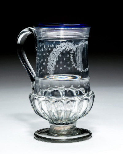 A BLUE RIMED GLASS COIN TANKARD