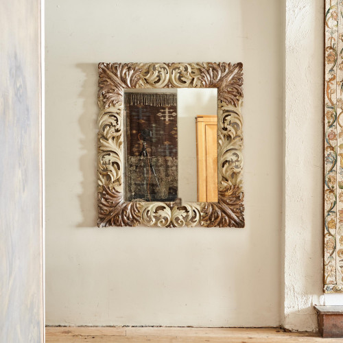 A rectangular Florentine mirror with a finely carved, painted and silver gilt frame