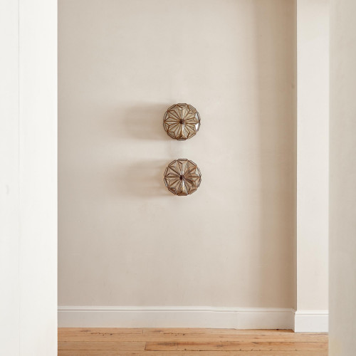 A pair of brass and glass wall lights by Taurus