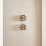 A pair of brass and glass wall lights by Taurus