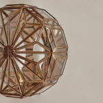 A pair of brass and glass wall lights by Taurus