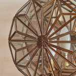 A pair of brass and glass wall lights by Taurus
