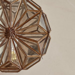 A pair of brass and glass wall lights by Taurus
