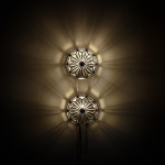 A pair of brass and glass wall lights by Taurus