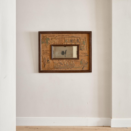 An unusual Arts & Crafts oak and embroidered mirror