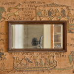 An unusual Arts & Crafts oak and embroidered mirror