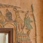 An unusual Arts & Crafts oak and embroidered mirror